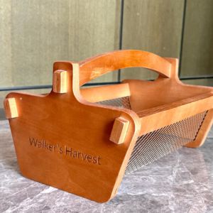 A wooden basket with a name on it