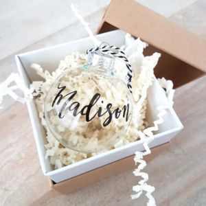 A personalized ornament in a gift box