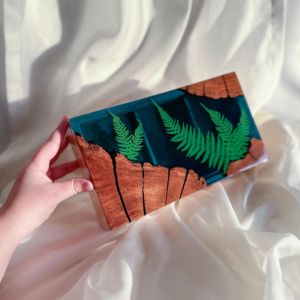 hand holding wooden jewelry box