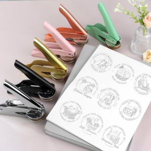 a few book embossers next to a book