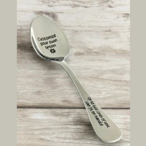 a spoon on a table with custom engraving