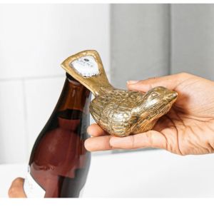 hand using bird shaped bottle opener