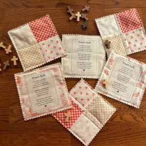 mini prayer quilts scattered on a table