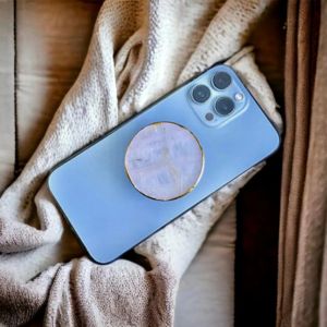 phone with a rose quartz pop socket
