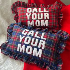 pillowswith christmas pattern and text embroidered on it