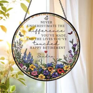 A floral suncatcher with happy retirement etched on it
