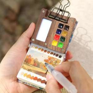 Portable watercolor set in hands