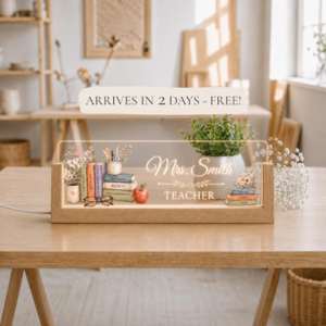 a persoanlzied led teacher sign sitting on top of a table