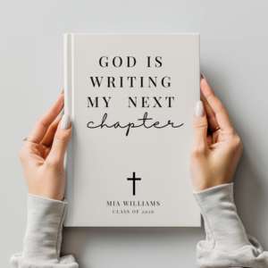 hands holding a notebook with text printed on it