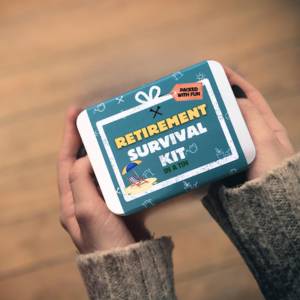 hands holding a tin box with retirement survival kit printed on it