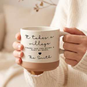 hands holding a white and brown coffee mug