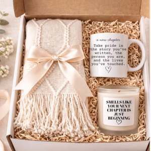 A gift basket with balnket and mug and candle
