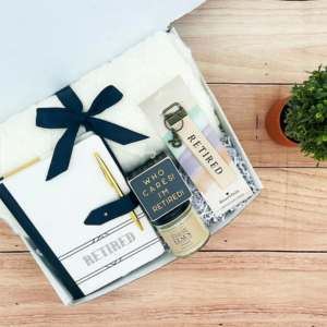 A gift box with things inside with tags that read retirement