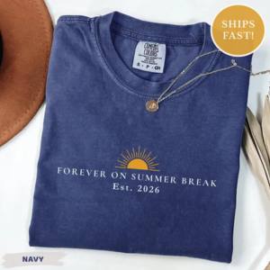 A navy blue pigment dyed cotton tee shirt with a gold sun graphic and text laid flat