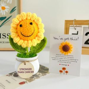 a crochet sunflower on a table with a card