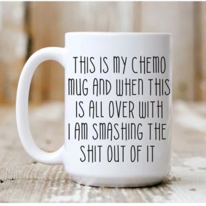 a mug on a table with large text printed on it