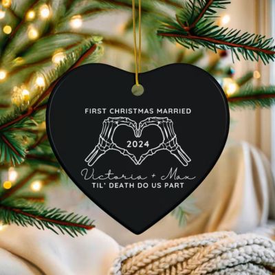 Black heart ornament with skeleton hands and couple names