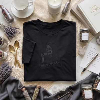 Black t-shirt with embroidered reaper drinking tea