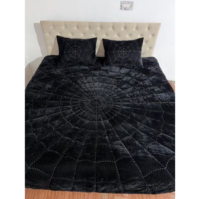 Black velvet quilt with spiderweb stitched pattern on bed