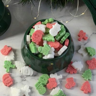 Colorful holiday shaped sugar cubes in green ceramic bowl