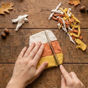 hands cutting clay using a knife