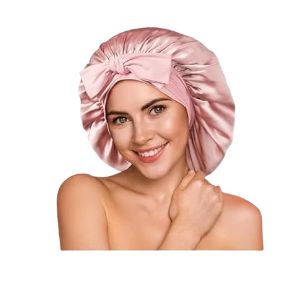 Pink mulberry silk bonnet with adjustable tie for protecting hair overnight.