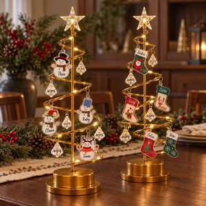 Small illuminated Christmas trees with personalized family name ornaments
