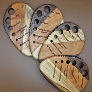 Handcrafted wooden herb stripper with herb labels